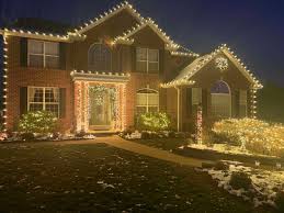Christmas light installation on stone-facade Connecticut estate